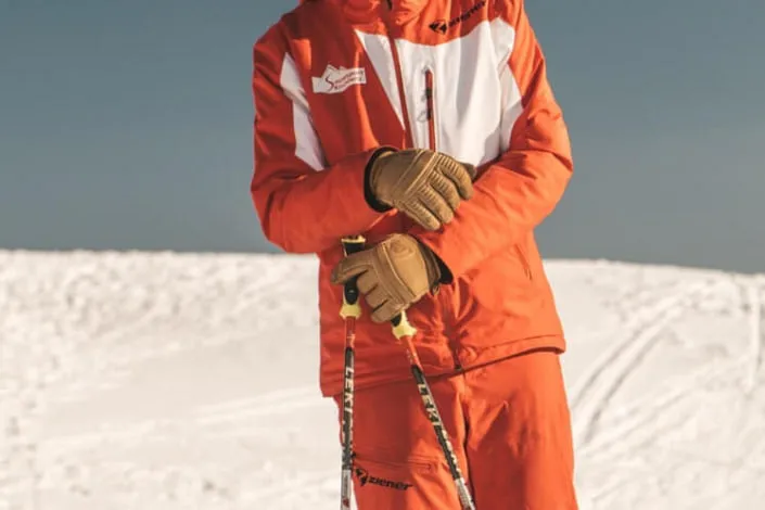 Skier in orange gear on snow