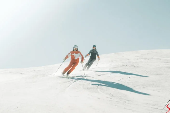 Two skiers on a snow-covered slope