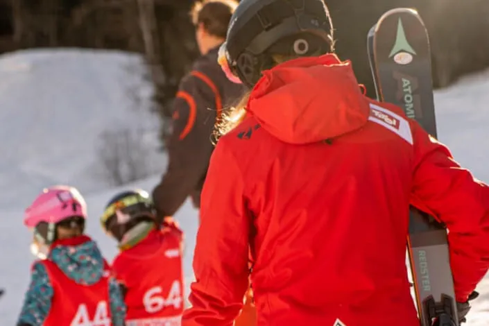 Skiers in red clothing at Kirchberg snow sports